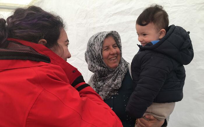 Frau und Junge lächeln nach dem Erdbeben in der Türkei Helferin an 