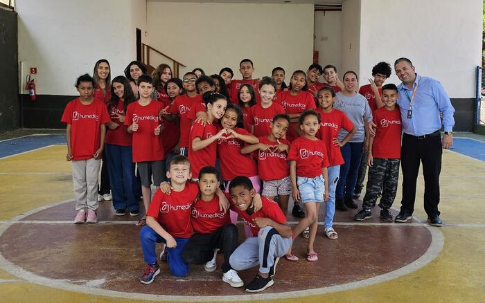 Kinder mit rotem humedica-T-Shirt stehen in einer Turnhalle