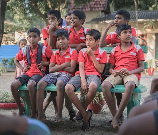 Jungen auf einer Bank in einem Innenhof in Sri Lanka