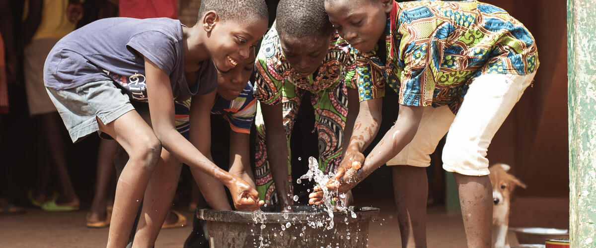 African children play with clean water